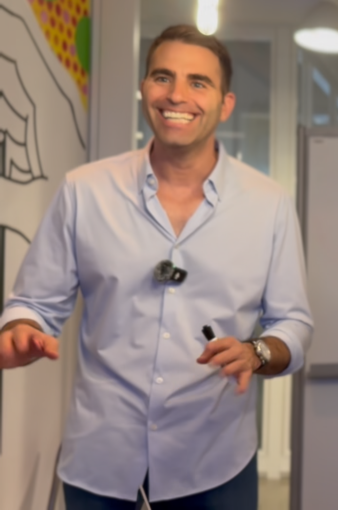 Josh Hedaya smiling while teaching